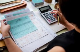 asian-woman-working-through-paperwork-min
