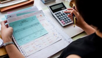 asian-woman-working-through-paperwork-min
